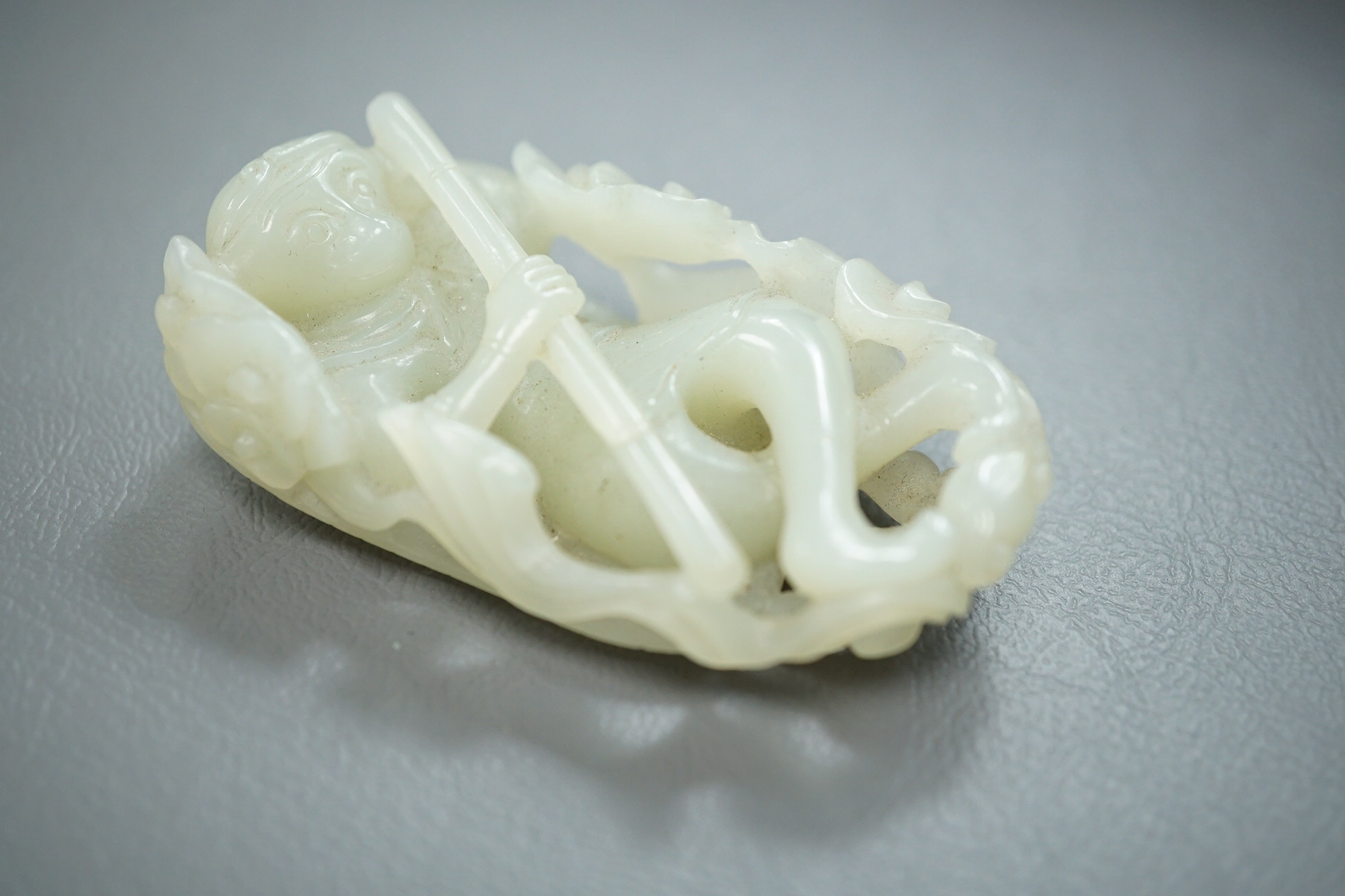 A Chinese pale celadon jade carving of Sun Wukong, the Monkey King, 18th/19th century